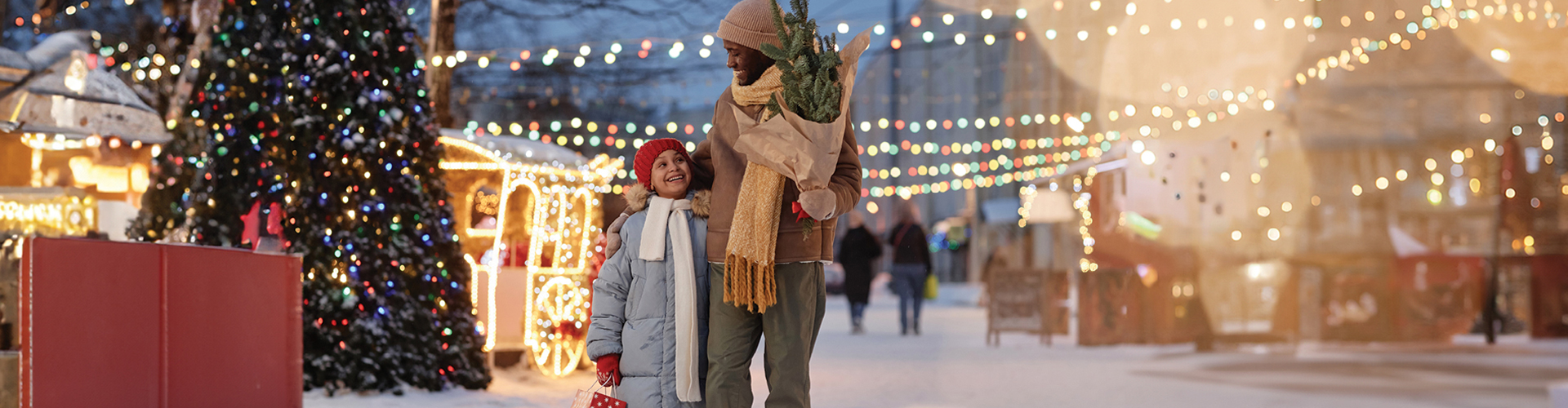 Father and daughter standing in a wintry scene