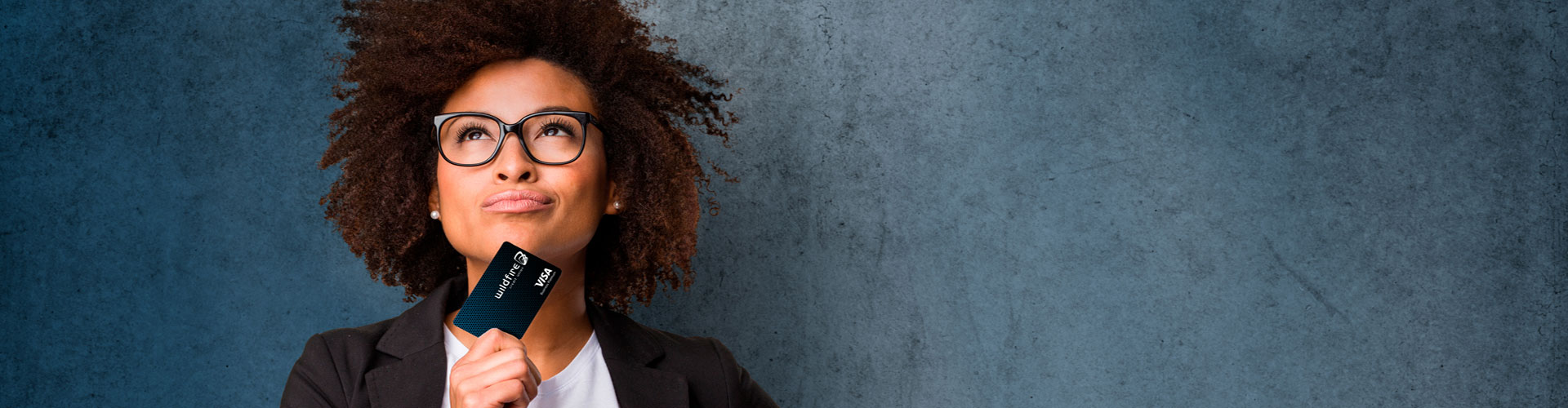 Woman with a credit card looking on confidently