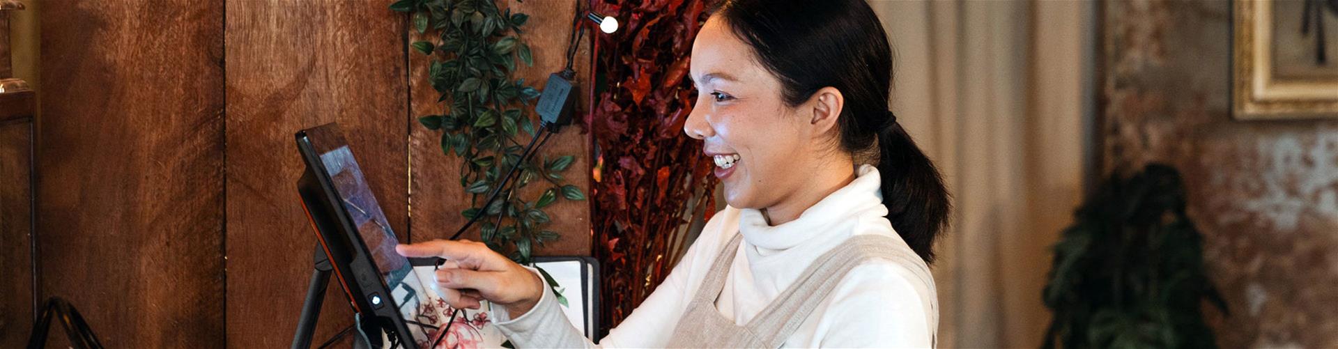 female waitress happily working with cash desk restaurant