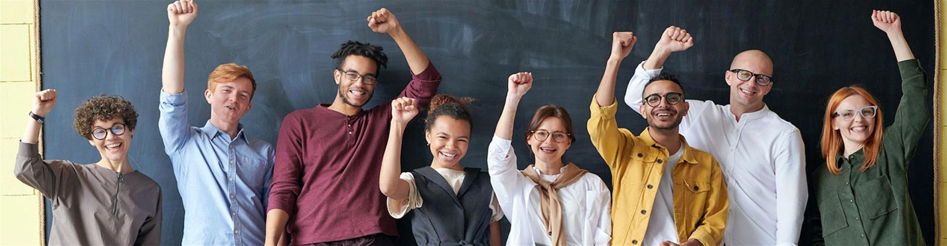 Joyful Work team celebrating with hands held high