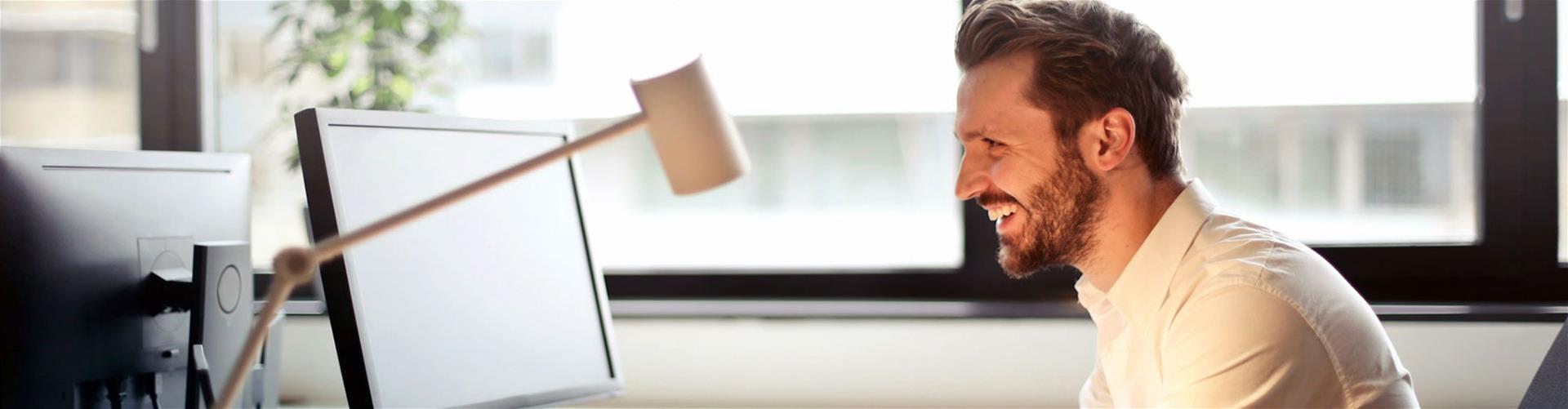 Smiling businessman working on computer