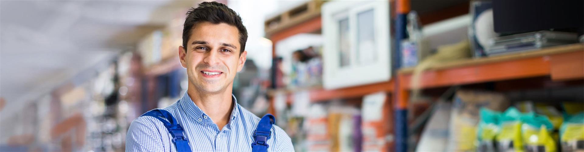 Man in overalls in a warehouse