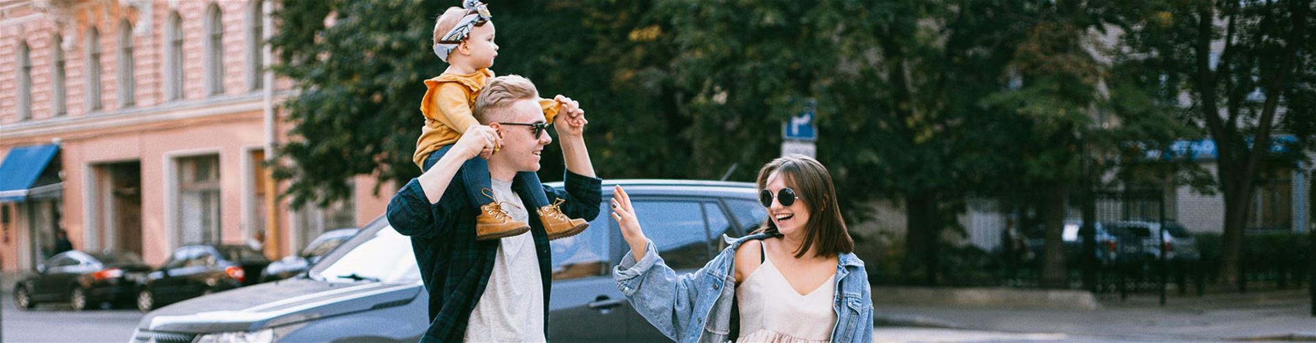 Young happy family walking through the city