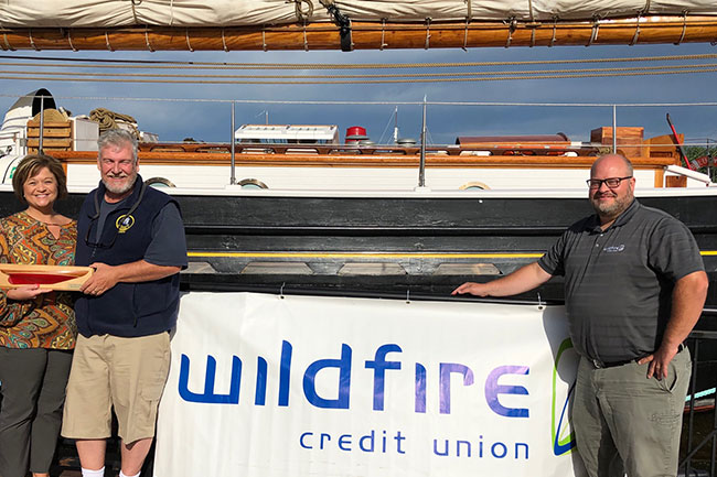 Ship captain  and Wildfire employee standing in front of ship