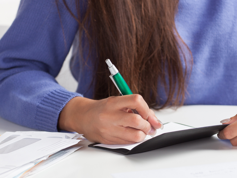 Manage your business account Woman writing a check