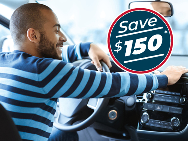 Gentleman sitting in his car smiling that he saved $150 off his first consumer loan payment.