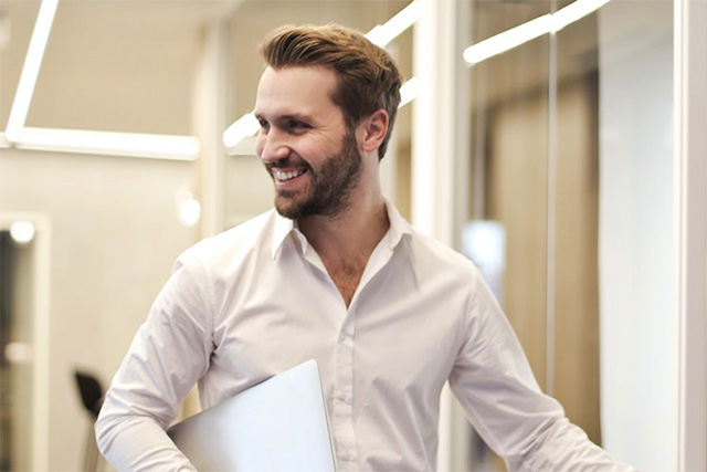 Man in an office looking behind him