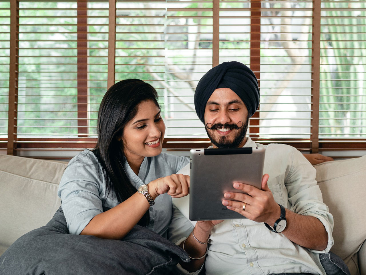 Couple happily using a tablet
