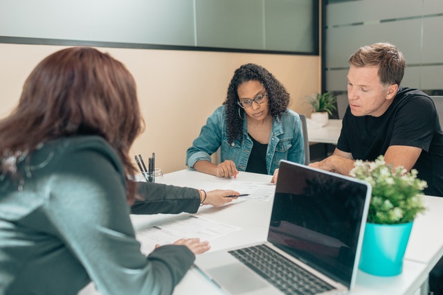 Couple sits with a financial advisor