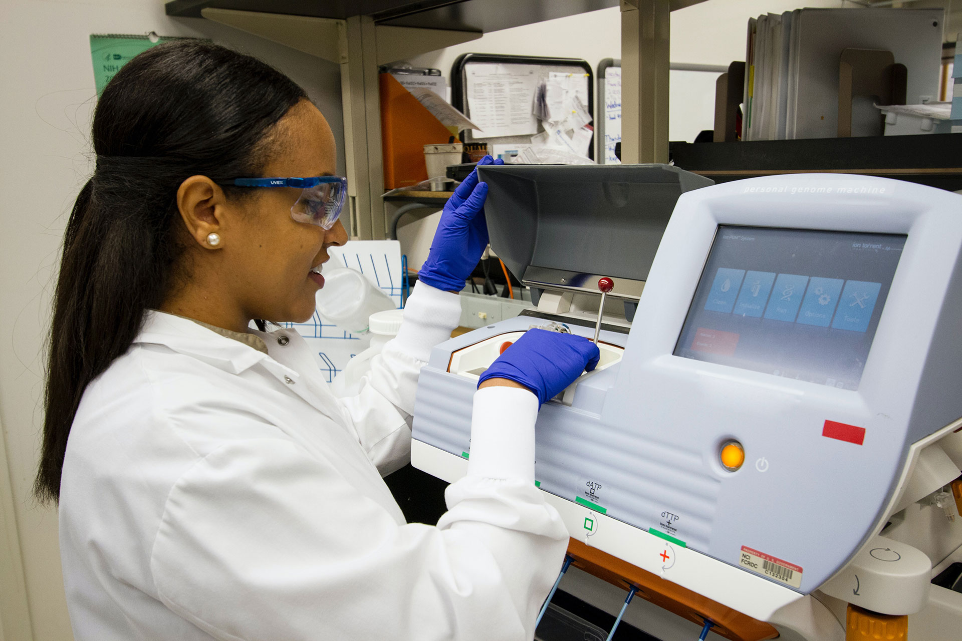 Female scientist happily working with lab equipment