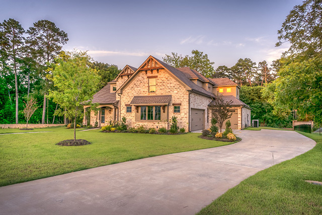 Exterior view of modern style home made of light brown brick as sunset