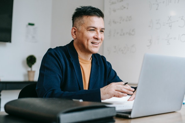 Man Looking Happily On His Laptop Man Looking Happily On His Laptop