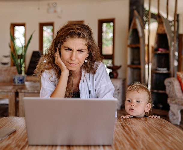 Mother and toddler son looking at laptop
