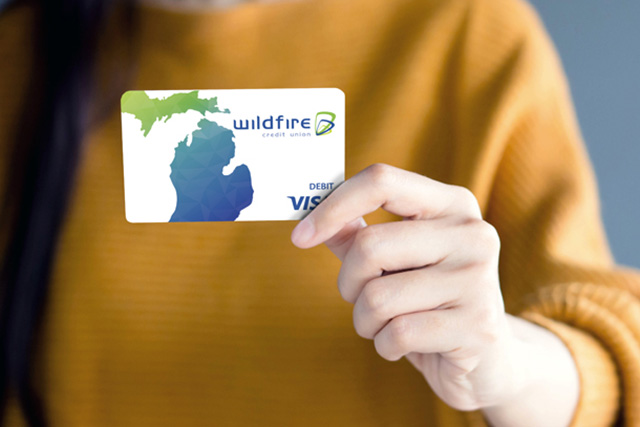 Person holding a Wildfire debit card