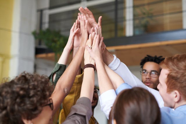 People in a circle putting their hands in