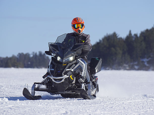 winter scene with person on snowmobile