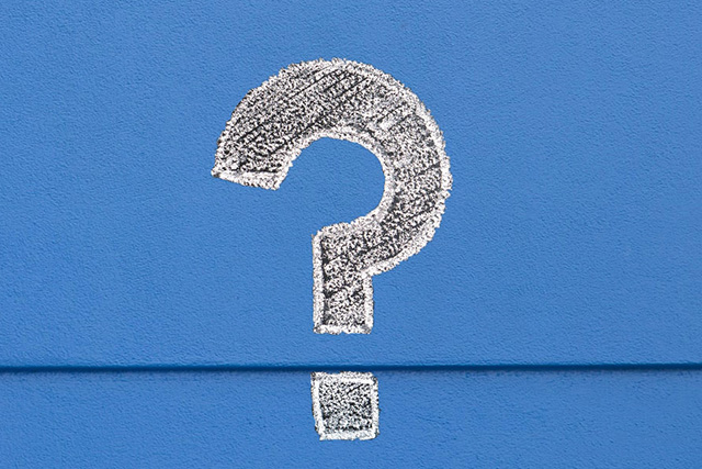 White chalk question mark on royal blue background
