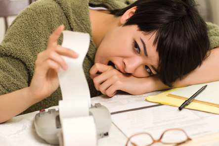 Woman stressed while paying bills