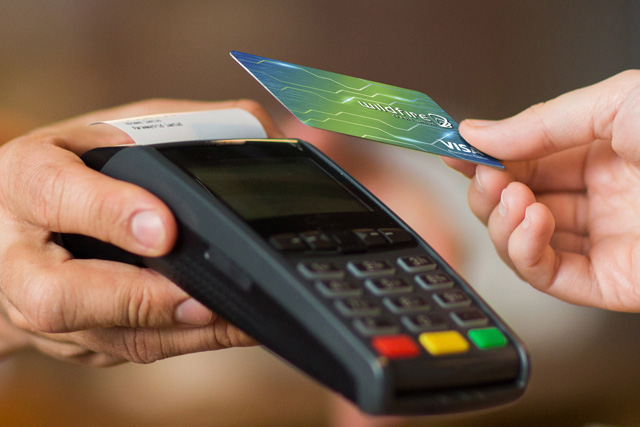 Person paying with a Wildfire business debit card