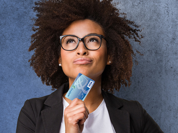 Happy Business woman holding Wildfire Visa Credit Card Happy Business woman holding Wildfire Visa Credit Card