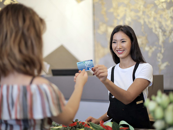 Business woman paying with Wildfire Visa credit card