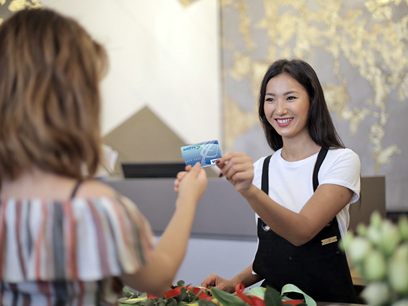 Business woman paying with Wildfire Visa credit card Business woman paying with Wildfire Visa credit card