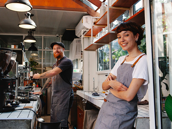 confident male and female shop owners making coffee confident male and female shop owners making coffee