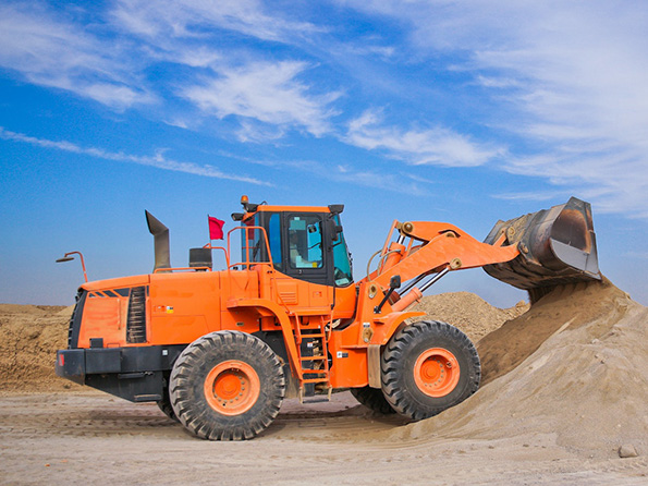 orange excavator shoveling sand orange excavator shoveling sand