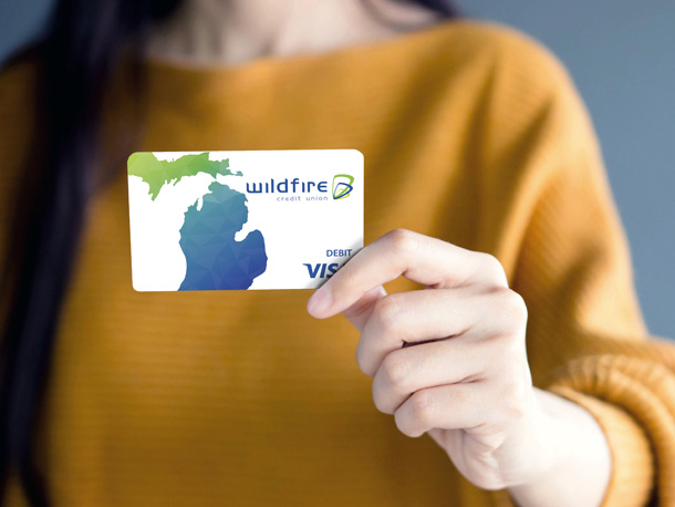 Person holding a wildfire debit card