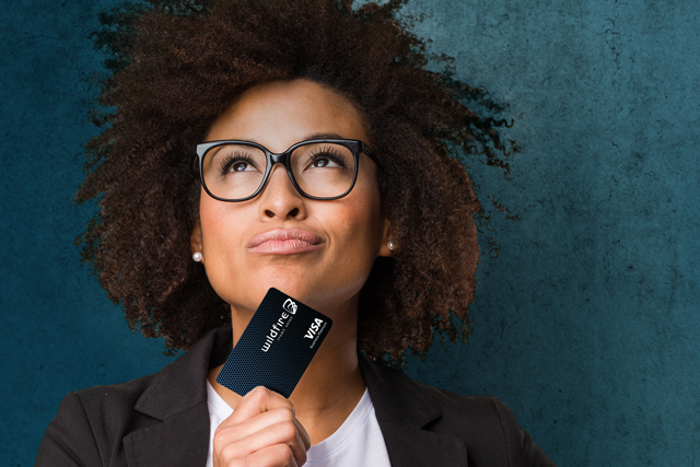 Woman with a credit card looking on confidently