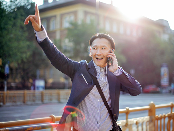 cheerful  businessman chatting on phone and waving