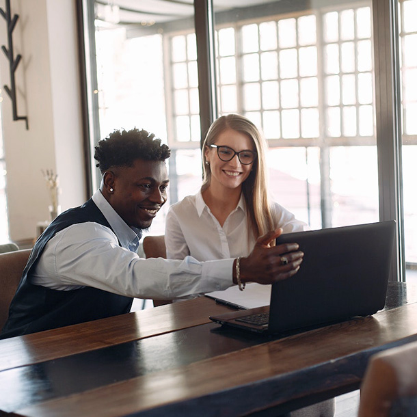 cheerful business partners working on laptop