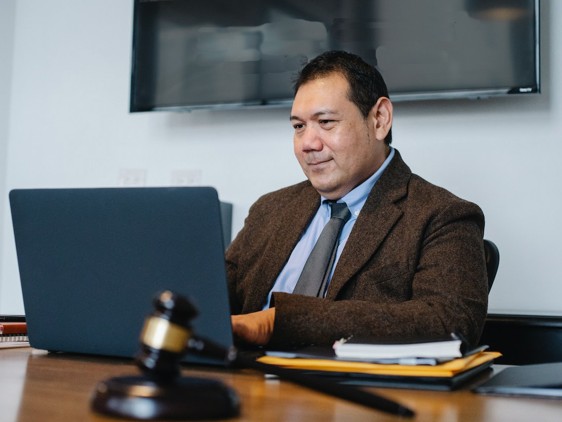 middle aged lawyer working on laptop in office