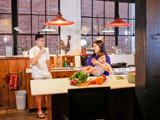 Happy parents with their baby in kitchen