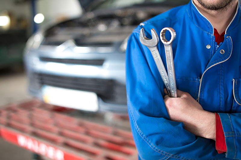 Mechanic Holding Wrenches