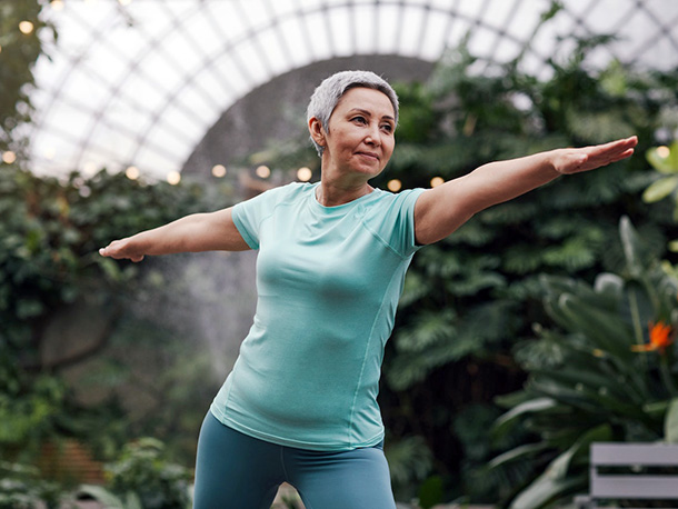 Woman doing yoga in indoor garden