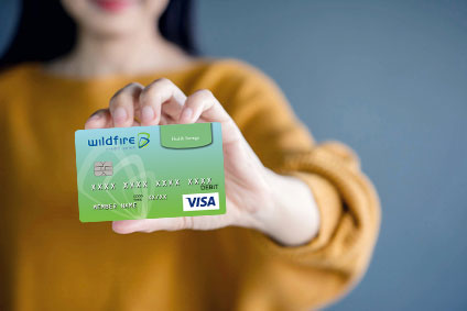 Woman holding a Wildfire HSA Debit Card Woman holding Wildfire HSA Debit Card