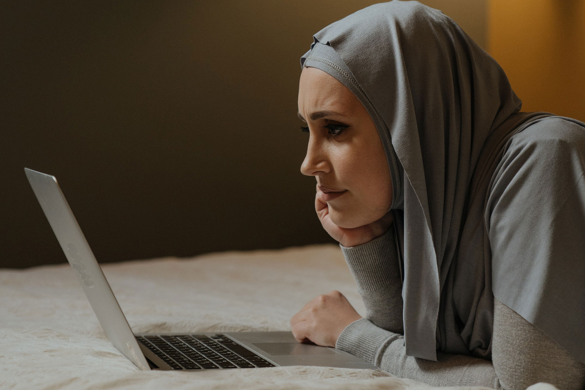 Woman in Gray Hijab using a laptop