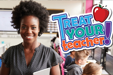 Happy Teacher standing in a classroom