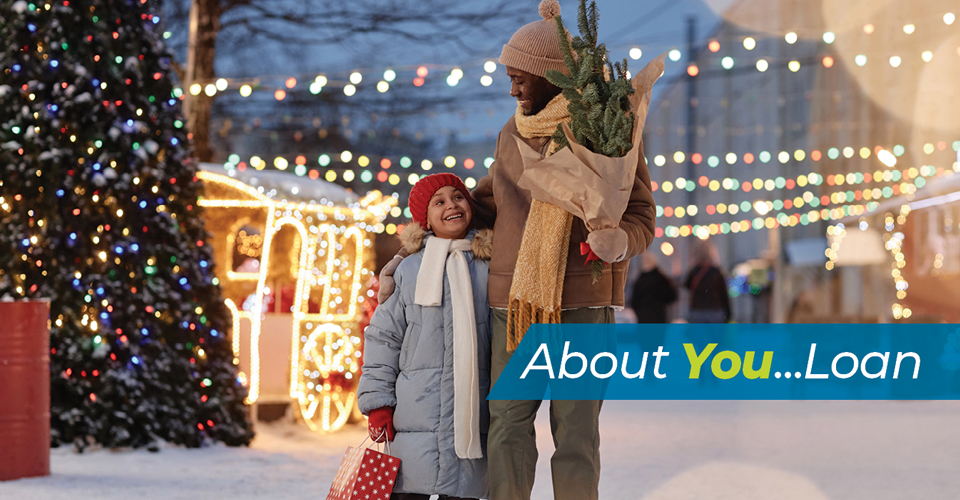 Father and daughter out in a wintry street for holiday fun.