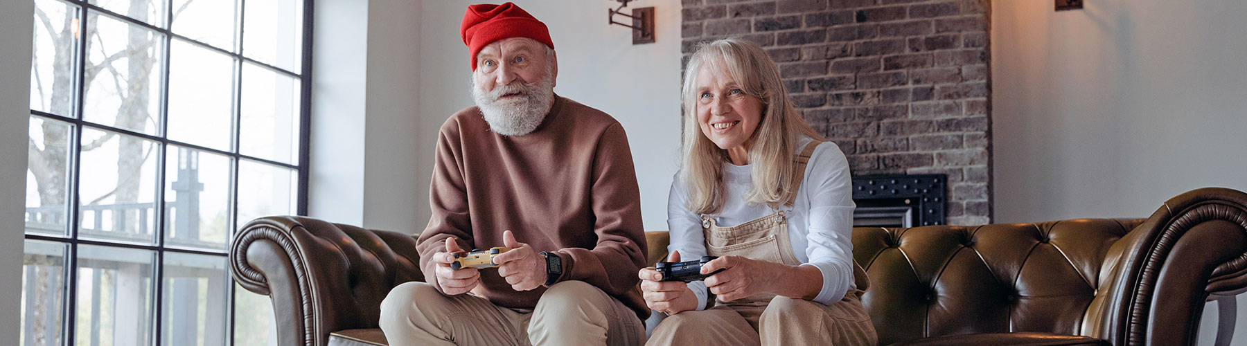 Senior couple excitedly playing video games