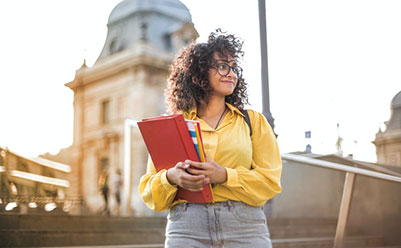 Female Student in Yellow Jacket Holding Red Book Female Student in Yellow Jacket Holding Red Book