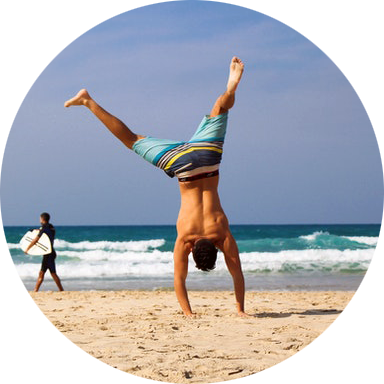 Man doing a handstand on the beach