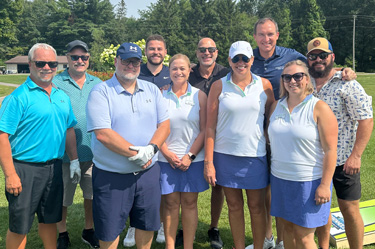 Wildfire employee posing for a picture at the Golf Outing