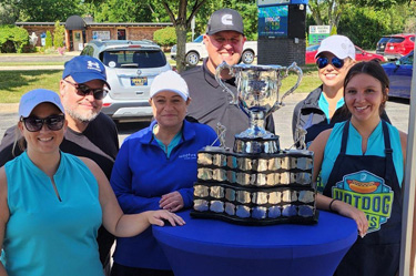 Wildfire Employees and Memorial Cup Trophy at Hot Dog Day Event